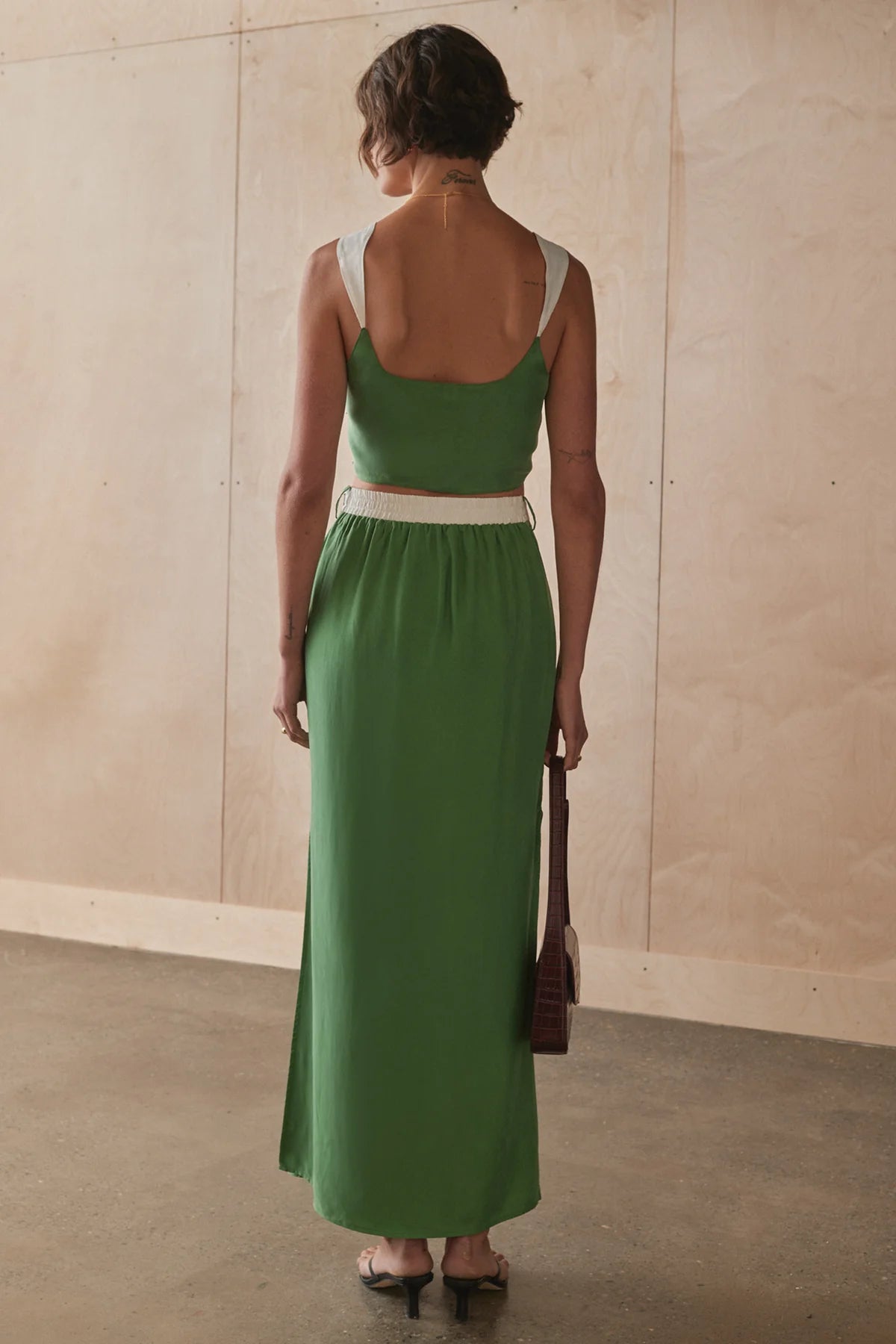 Sancia Rosetta Skirt - Matcha Front View close up back view at cloth in brick
