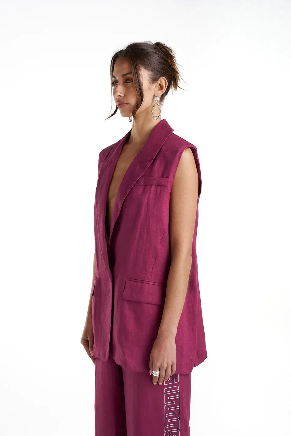 Sleeveless Blazer - Plum Summi Summi side view at cloth in brick
